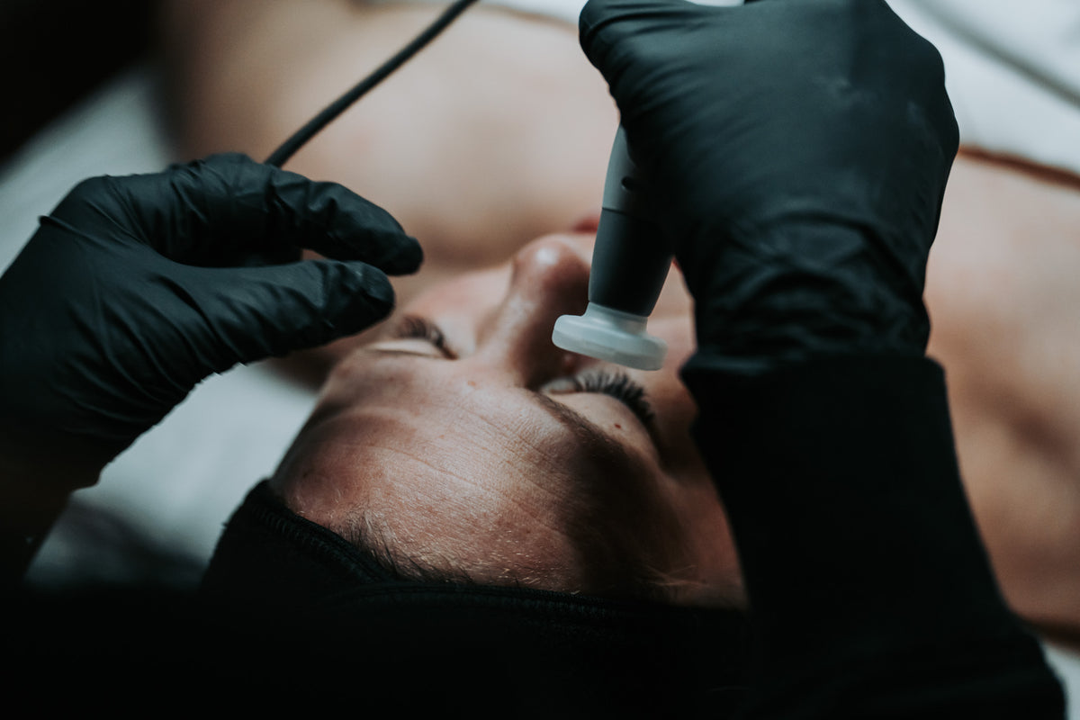 Client receiving a Cold Jet Plasma treatment at Aging Gracefully Skin Experts in Seattle
