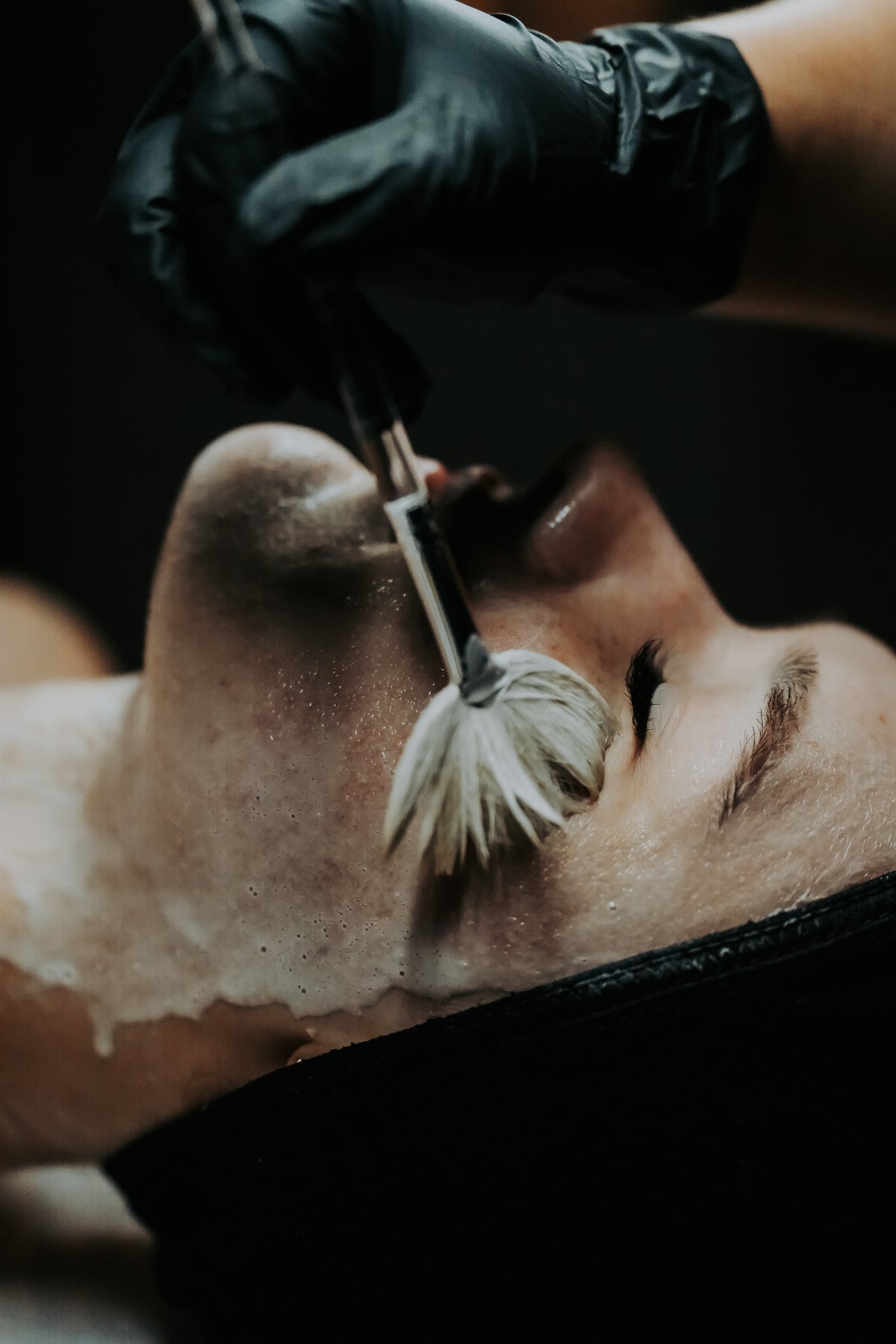 Client receiving a cleanse with brush at Aging Gracefully Skin Experts in Seattle