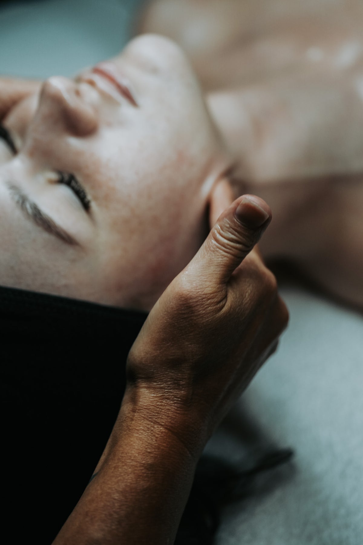 Client receiving facial massage at Aging Gracefully Skin Experts in Seattle